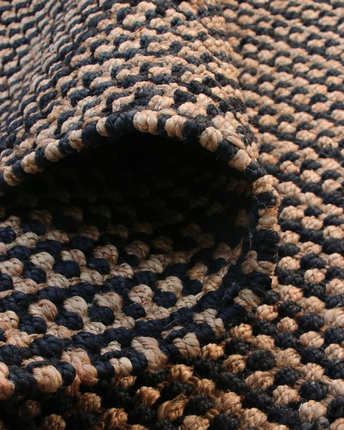Folded piece showing the deep, tactile relief of its 18mm pile height. An ethically produced GoodWeave certified design.