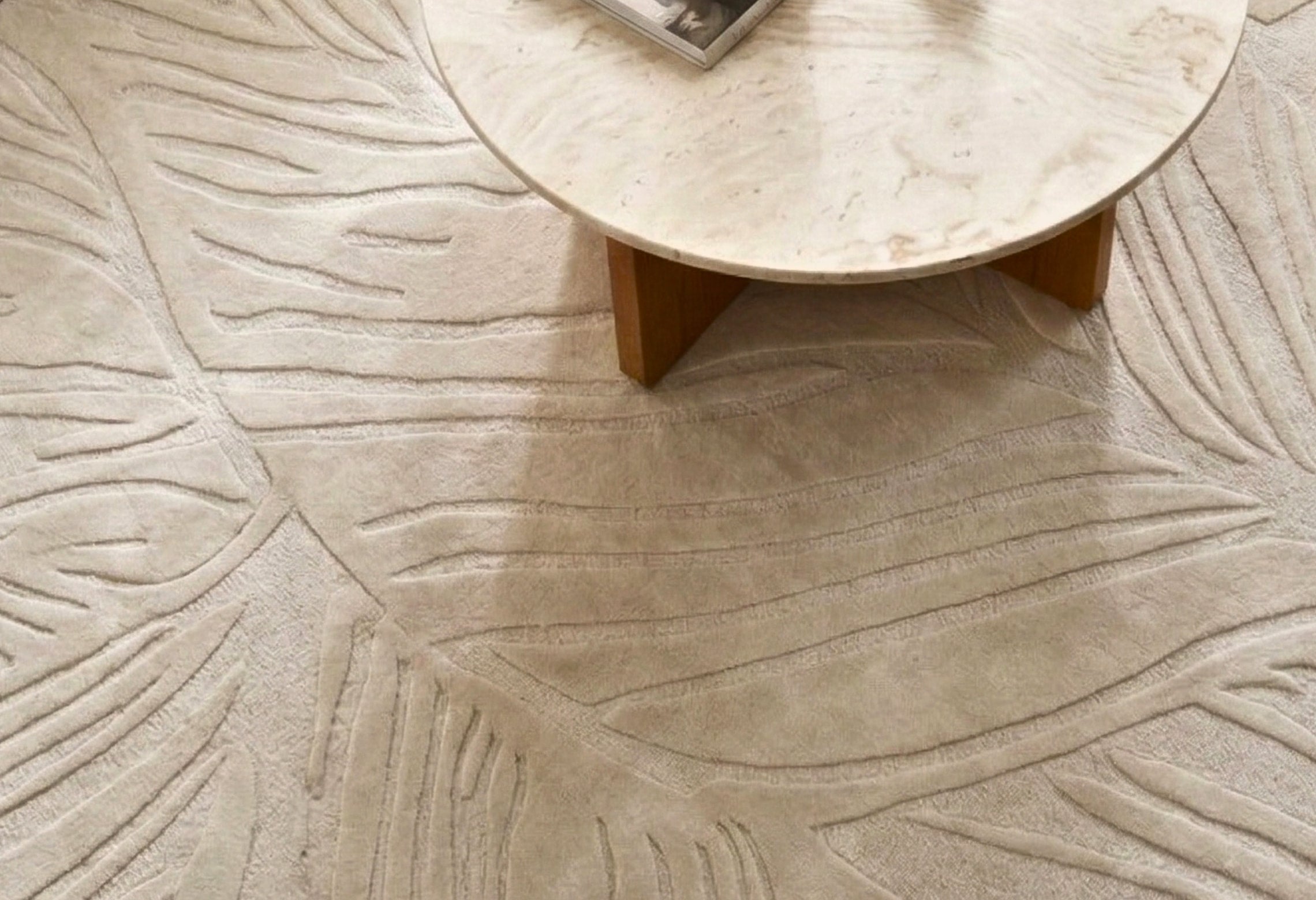 Sway hand-tufted wool rug in ivory by House of Bohi, styled with a travertine coffee table on a timber base, showcasing the bespoke quality House of Bohi offers to interior designers, architects and stylists through its Australian trade program.